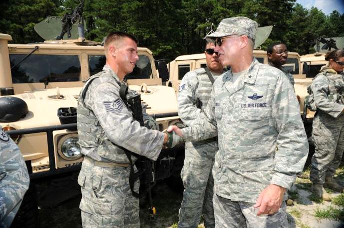 Brig. Gen. Richard Devereaux, U.S. Air Force Expeditionary Center commander, greets Tech. Sgt. James Chubb, 421st Combat Training Squadron, after a convoy demonstration for civic leaders during the Center's Outreach Day, July 21 at Joint Base McGuire-Dix-Lakehurst, N.J. (U.S. Air Force photo by Carlos Cintron)