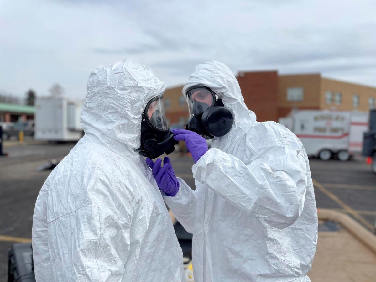 ONG 52nd Civil Support Team members prepare to enter an incident area to assess remaining hazards with a lightweight inflatable decontamination system (LIDS) in East Palestine, Ohio, on Feb. 7, 2023. (Ohio National Guard via AP)