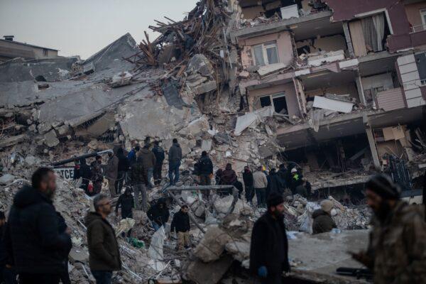 People wait for news of their loved ones, believed to be trapped under collapsed buildings in Hatay, Turkey, on Feb. 9, 2023. (Burak Kara/Getty Images)