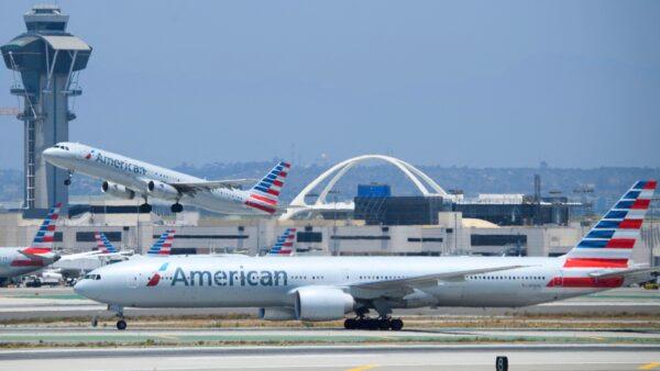 An American Airlines Airbus A321 aircraft takes off as a Boeing 777-300 taxis on the tarmac at Los Angeles International Airport in Los Angeles on July 6, 2021. (Patrick Fallon/AFP via Getty Images)