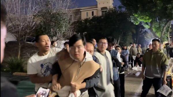 Attendees at a vigil commemorating Dr. Li Wenliang restrain a man who reportedly vandalized the event in front of the Chinese Consulate in Los Angeles on Feb. 4, 2023. (Courtesy of Jie Li-Jian)