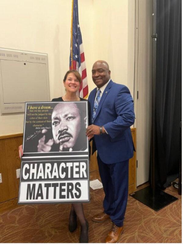 Lori Gimelshteyn (L), co-founder of CPAN, with Cain Young (R), director of Task Force Freedom in Larimer and Weld counties, with an MLK poster autographed by King's niece Dr. Alveda King, who spoke at CPAN's kickoff event on Nov. 13, 2022. (Courtesy of Lori Gimelshteyn)