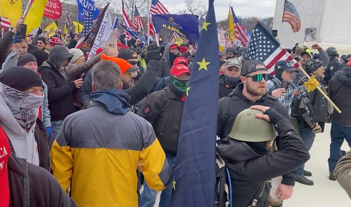 Proud Boys defendant Ethan Nordean (right, mirror shades) was among protesters on the west side of the U.S. Capitol on Jan. 6, 2021. (U.S. Department of Justice/Screenshot via The Epoch Times)