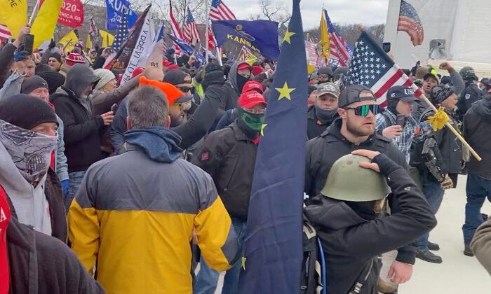 Proud Boys defendant Ethan Nordean (right, mirror shade) on the west side of the U.S. Capitol on Jan. 6, 2021. (U.S. Department of Justice/Screenshot via The Epoch Times)