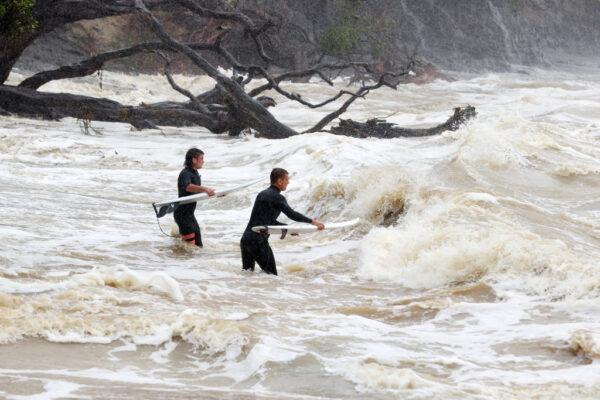 Surfers head out into large waves and rough seas from Cyclone Gabrielle at Goat Island Marine Reserve in Auckland, New Zealand, on Feb. 13, 2023. (Fiona Goodall/Getty Images)