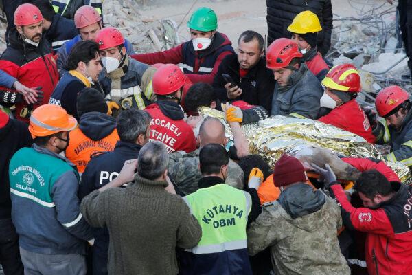Rescuer workers carry Kaan, a 13-year-old Turkish teenager, to an ambulance after being rescued from the rubble after 182 hours, in the aftermath of a deadly earthquake in Hatay, Turkey Feb. 13, 2023. (Dilara Senkaya/Reuters)