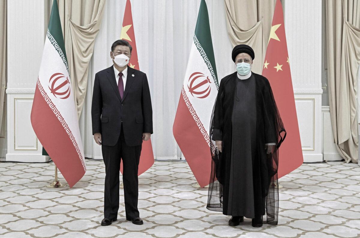 In this file photo released by China's Xinhua News Agency, Iran's President Ebrahim Raisi (R) and Chinese leader Xi Jinping pose for a photo on the sidelines of a meeting at the Shanghai Cooperation Organization summit in Samarkand, Uzbekistan, on Sept. 16, 2022. (Shen Hong/Xinhua via AP, File)