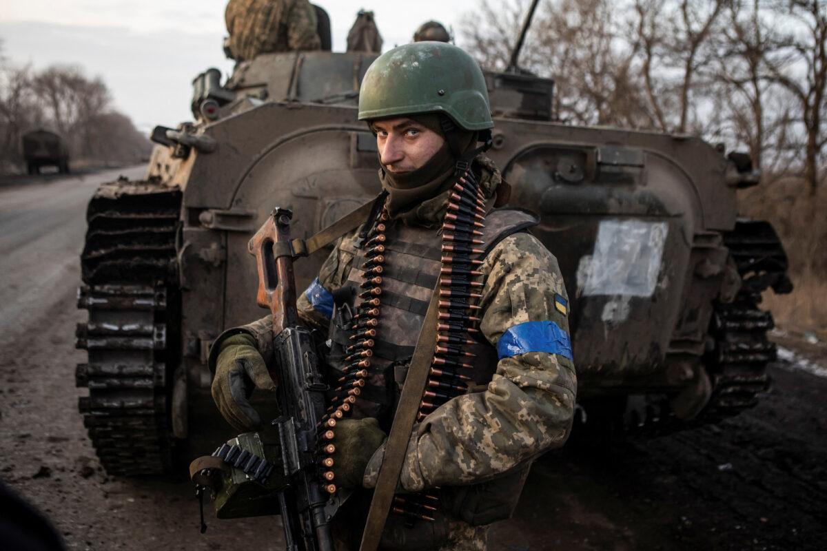 A Ukrainian serviceman stands on the road outside the frontline town of Bakhmut, Ukraine, on Feb. 11, 2023. (Yevhenii Zavhorodnii/Reuters)