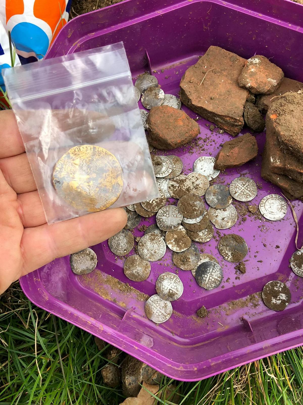 Gold and silver coins being packaged at the dig site near Hambleden, Buckinghamshire. (SWNS)