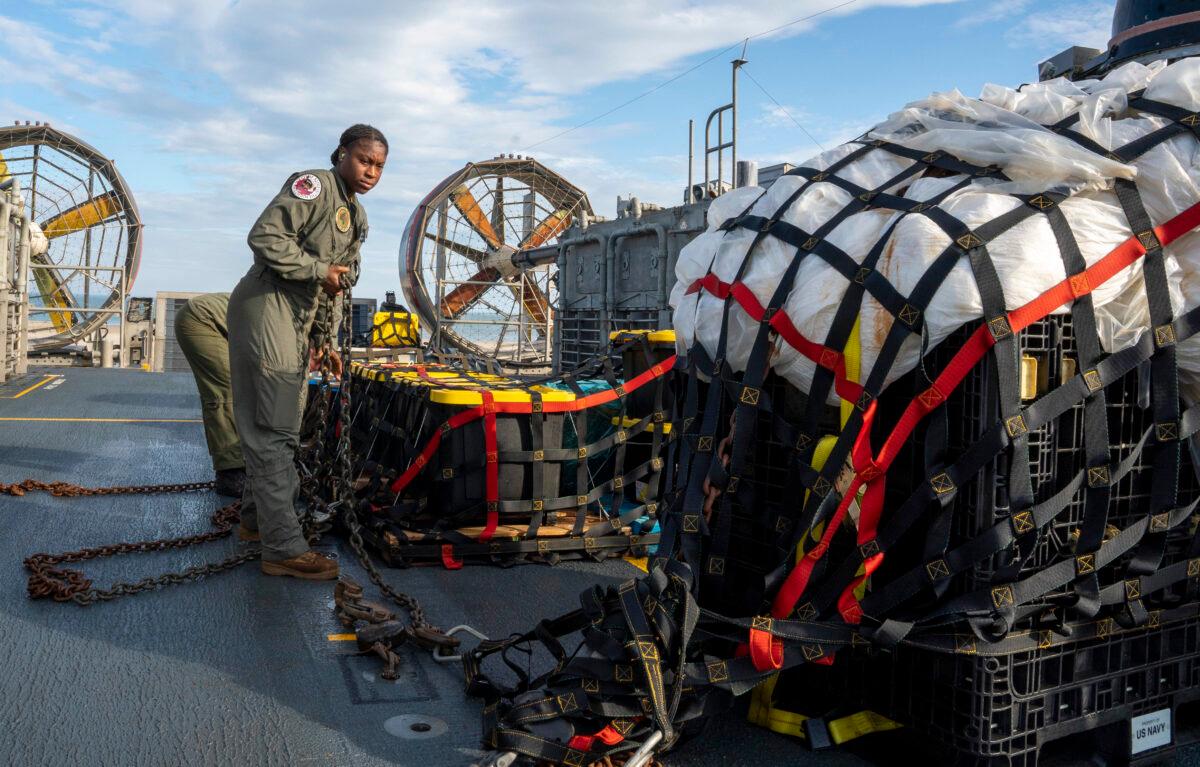 Sailors prepare material recovered in the Atlantic Ocean from a China-claimed high-altitude balloon for transport to federal agents at Joint Expeditionary Base Little Creek on Feb. 10, 2023. (Ryan Seelbach/U.S. Navy via Getty Images)
