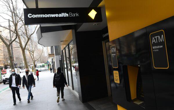 People walk past a branch of the Commonwealth Bank of Australia in Melbourne, Australia, on Aug. 11, 2021. (William West/AFP via Getty Images)