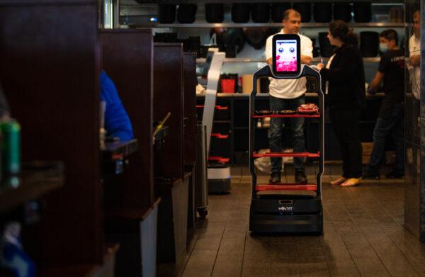 A robot delivers food orders at I Can Korean Barbecue in Tustin, Calif., on Feb. 14, 2023. (John Fredricks/The Epoch Times)
