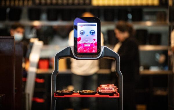 A robot delivers food orders at I Can Korean Barbecue in Tustin, Calif., on Feb. 14, 2023. (John Fredricks/The Epoch Times)