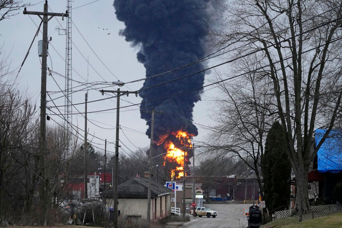 A black plume rises as a result of a controlled detonation of a portion of the derailed Norfolk Southern freight train in East Palestine, Ohio, on Feb. 6, 2023. (Gene J. Puskar/AP Photo)