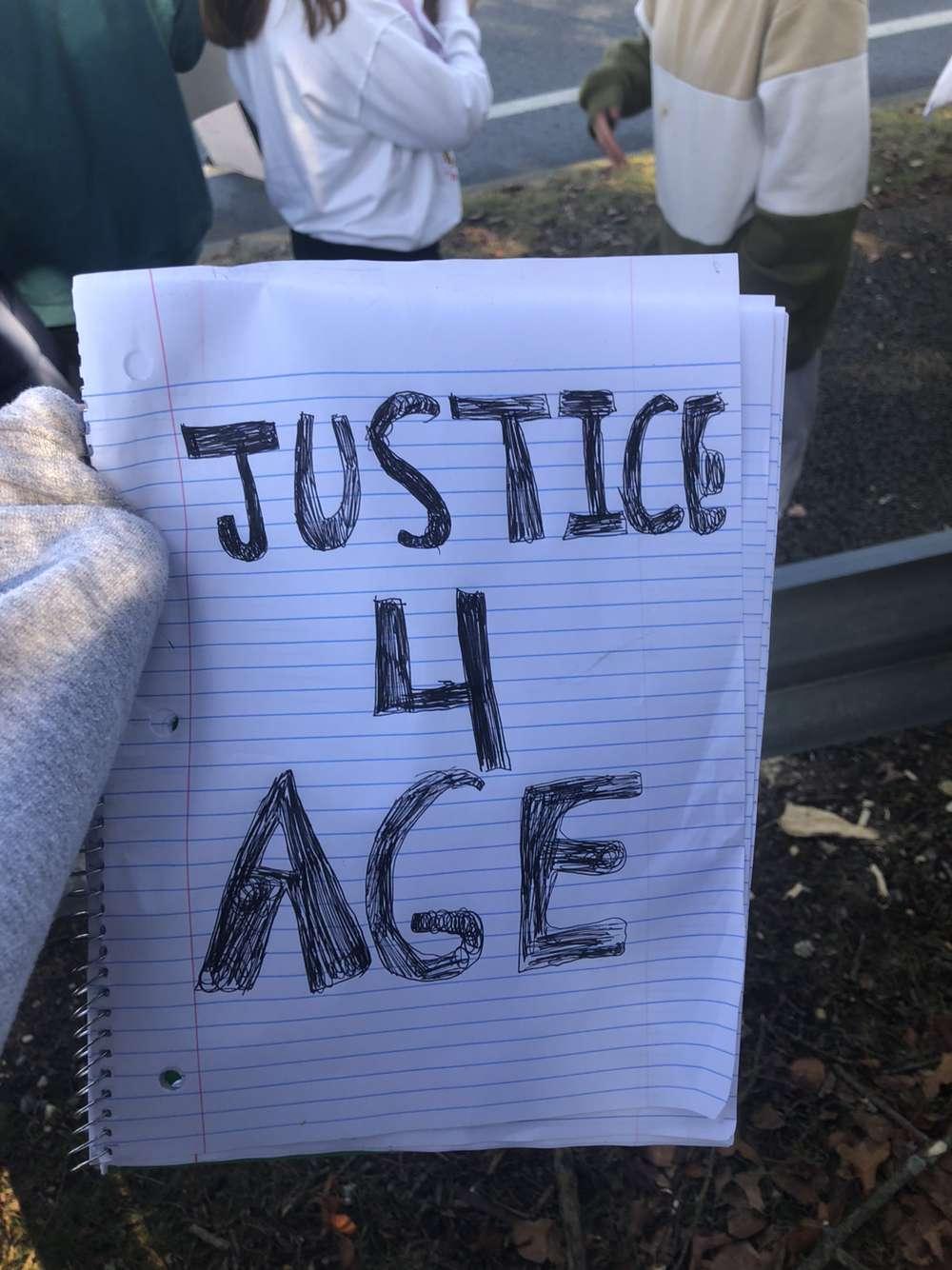 Meredith holds a sign demanding justice for her friend Adriana "Age" Kuch. The photo was taken the week of Feb. 5, 2023, in Bayville, N.J. (Courtesy of Meredith)