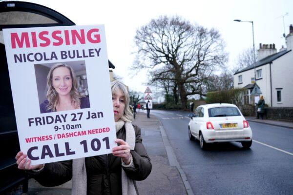 A woman holds up a placard during the search for Nicola Bulley, who went missing in Lancashire, England, on Jan. 27, 2023. (PA)