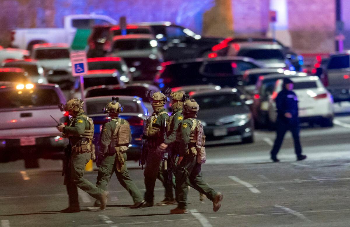 Law enforcement agents walk in the parking lot of a shopping mall in El Paso, Texas, on Feb. 15, 2023. (Andrés Leighton/AP Photo)