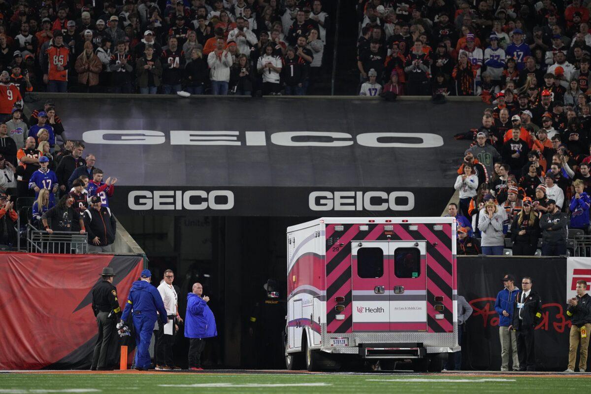 Fans look on as the ambulance leaves carrying Damar Hamlin of the Buffalo Bills after he collapsed at Paycor Stadium in Cincinnati on Jan. 2, 2023. (Dylan Buell/Getty Images)