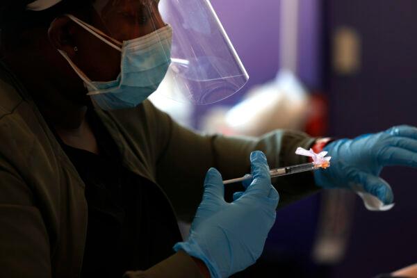 A nurse administers a COVID-19 vaccine during an event held by the San Francisco 49ers and other groups in Santa Clara, Calif., on April 8, 2021. (Justin Sullivan/Getty Images)