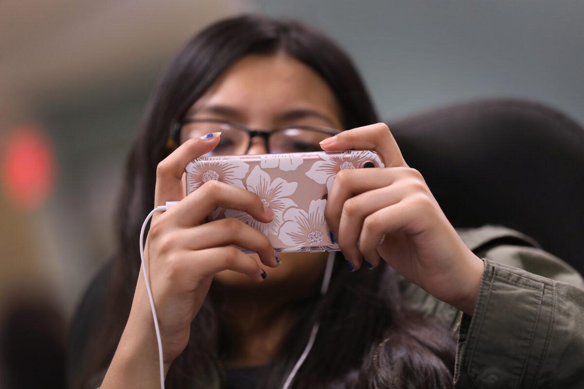 A girl plays a game on her phone in Stamford, Conn., on March 25, 2017. (John Moore/Getty Images)