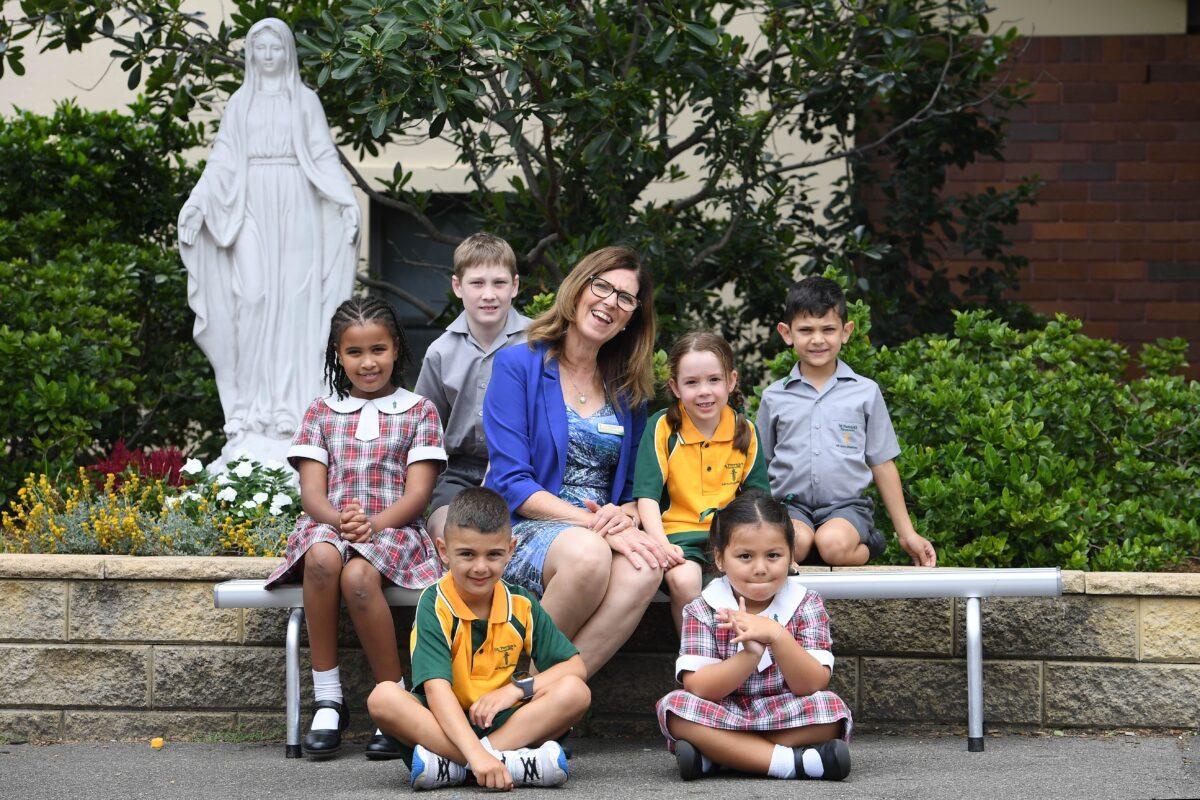 Principal Bernadette Fabri, along with students, pose for a photograph at St Patrick's Primary Parramatta in Sydney to mark 200 years of Catholic education in Australia on Feb. 18, 2021. (Dan Himbrechts/AAP Image)