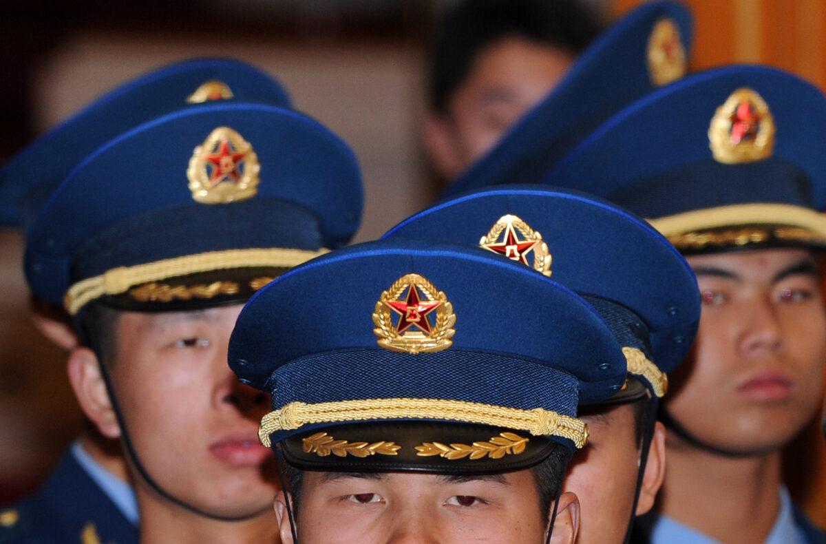 Chinese military honor guards representing the Air Force march inside the Great Hall of the People in Beijing on Nov. 9, 2010. (Frederic J. Brown/AFP via Getty Images)