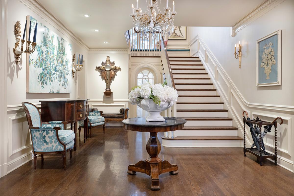 The entryway opens up to a statement staircase and many French antiques. (Handout/TNS)