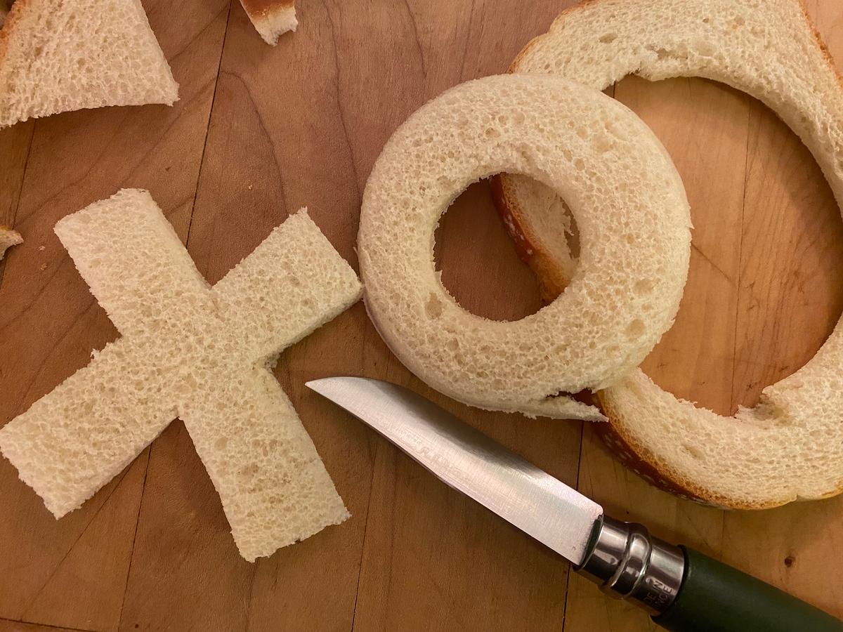 Step 9: Cut selected initial(s), numeral(s) or symbol(s) out of slice(s) of white bread with a sharp knife. (Note: The bread scraps are ideal for sponging the left-behind cheese sauce from your pan and bowl into your mouth). (Bethany Jean Clement/The Seattle Times/TNS)