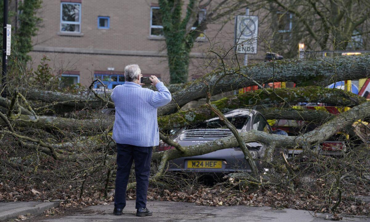 A Porsche 911 car is damaged by a fallen tree in Harrogate, North Yorkshire, as a result of storm Otto, on Feb.17, 2023. (Danny Lawson/PA Media)