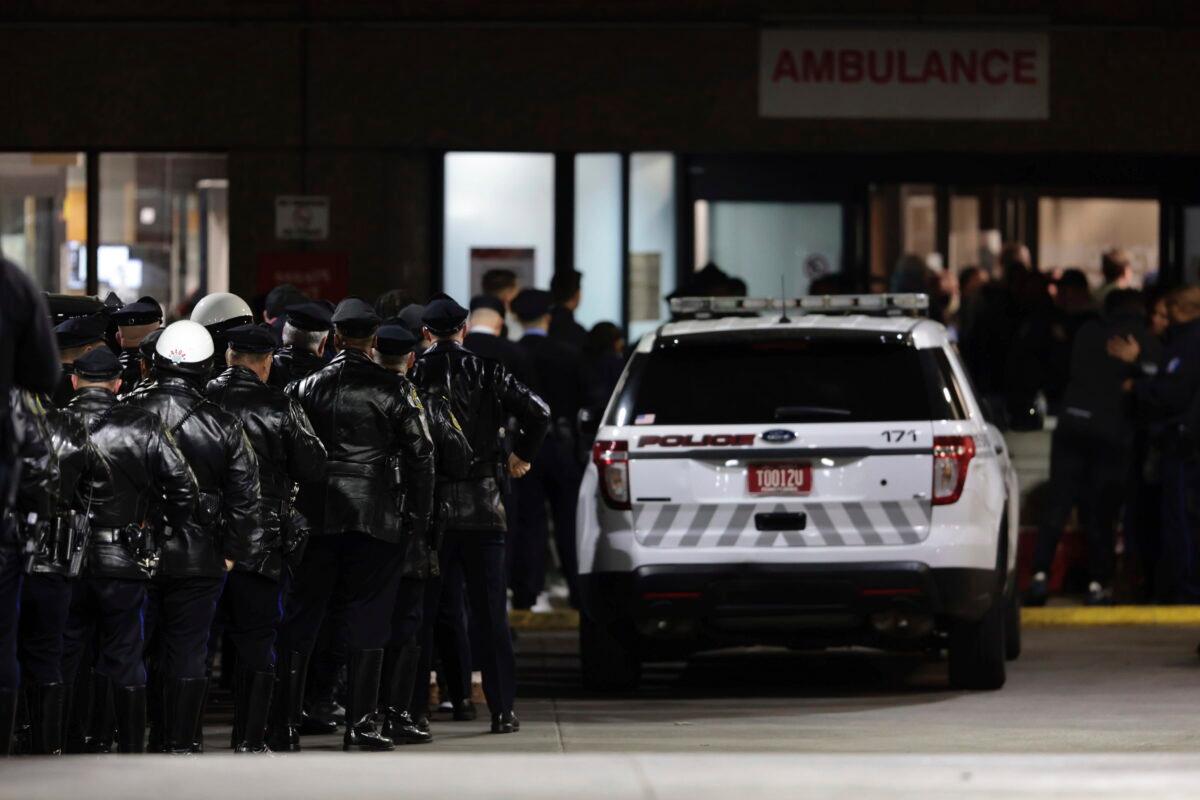 Police gather at Temple University Hospital following a fatal shooting of a Temple University police officer near the campus in Philadelphia on Feb. 18, 2023. (Elizabeth Robertson/The Philadelphia Inquirer via AP)