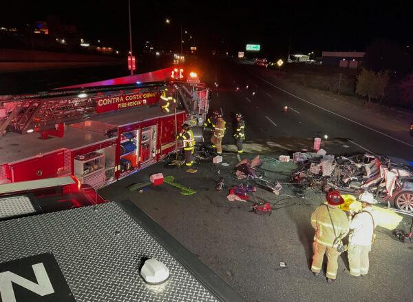 Firefighters work the scene of a fatal accident involving a Tesla and Contra Costa County fire truck in Contra Costa, Calif., on Feb. 18, 2023. (Contra Costa County Fire Protection District via AP)