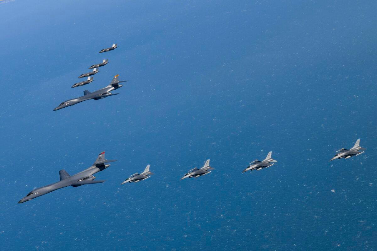 U.S. Air Force B-1B bombers (C) fly in formation with South Korea's Air Force F-35A fighter jets (top) and U.S. Air Force F-16 fighter jets (bottom) over the South Korea Peninsula during a joint air drill in South Korea on Feb. 19, 2023. (South Korea Defense Ministry via AP)