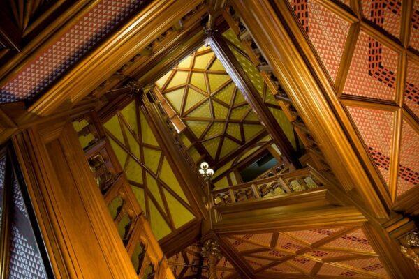 Nineteenth-century New York architect Edward Tuckerman Potter, who specialized in church designs, was responsible for the elaborate wood molding design in the Mark Twain House entryway and stairwell. The artistic and lofty solid-wood star patterns are juxtaposed with a decorative wall treatment background to achieve a stunning effect. (Courtesy of the Mark Twain House)