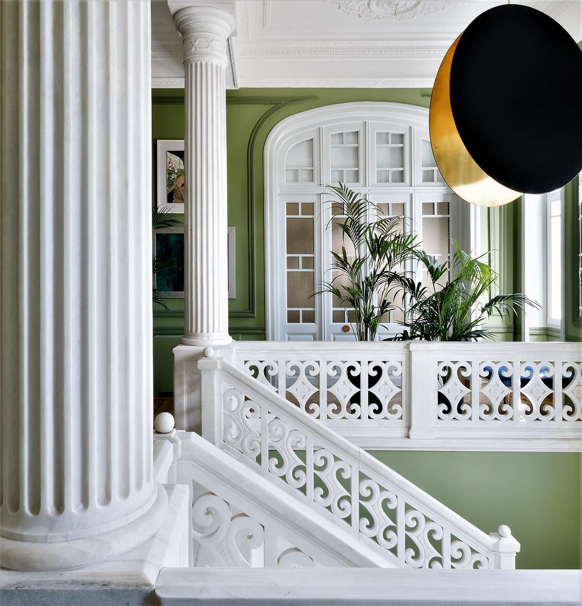 The home’s foyer features a classic marble staircase with Doric columns. Verdant colors and contrasts combined with grand dimensions to create an air of luxury. (Courtesy of Greece Sotheby’s International Realty)