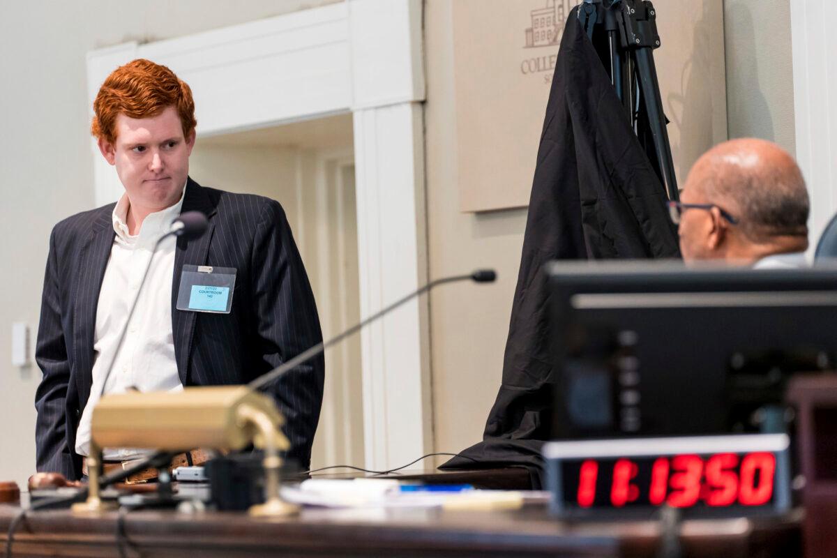 Buster Murdaugh (L), the son of Alex Murdaugh, listens to instruction from Judge Clifton Newman before a break during his father's trial at the Colleton County Courthouse in Walterboro, S.C., on Feb. 21, 2023. (Jeff Blake/The State via AP, Pool)