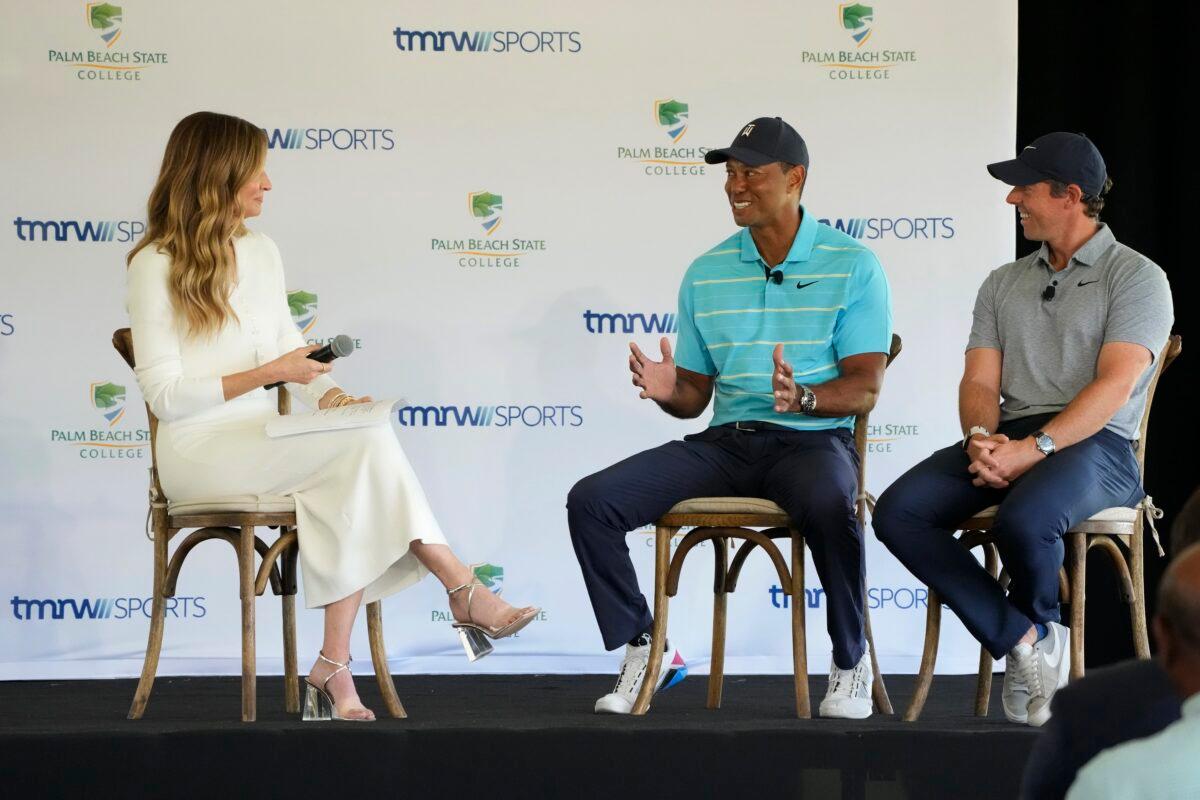 Golfers Tiger Woods (C) and Rory McIlroy (R) talk to host Erin Andrews as they discuss the future home of their tech-infused golf league that will begin play next year on the campus of Palm Beach State College in Palm Beach Gardens, Fla., on Feb. 21, 2023. (Wilfredo Lee/AP Photo)