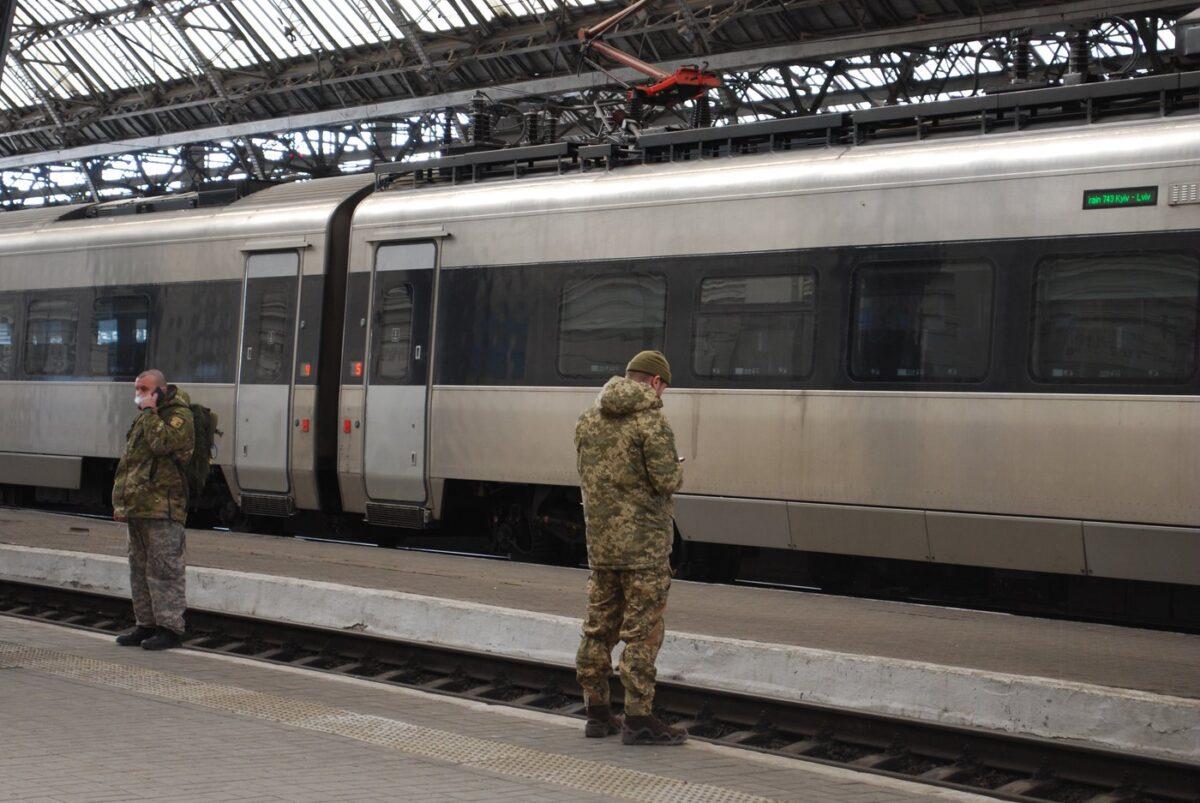 Passengers and military personnel wait on the platform of the Lviv train station in Western Ukraine on Feb. 18, 2023. (The Canadian Press/Laura Osman)
