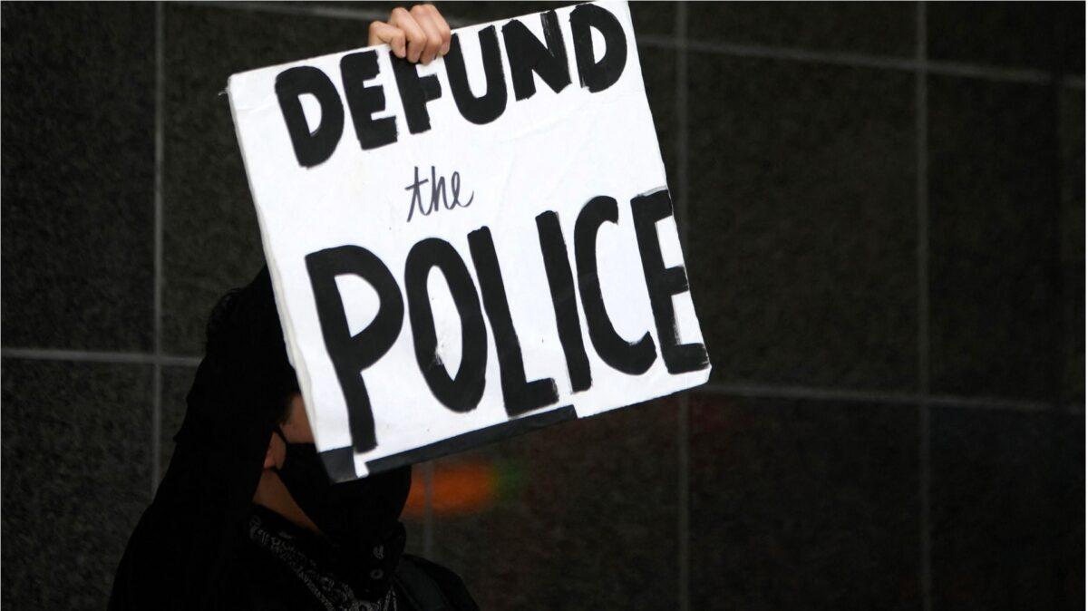 A protester holds a sign during a rally outside of the Federal Courthouse in Houston, Texas, on Jan. 28, 2023. (Mark Felix/AFP via Getty Images)