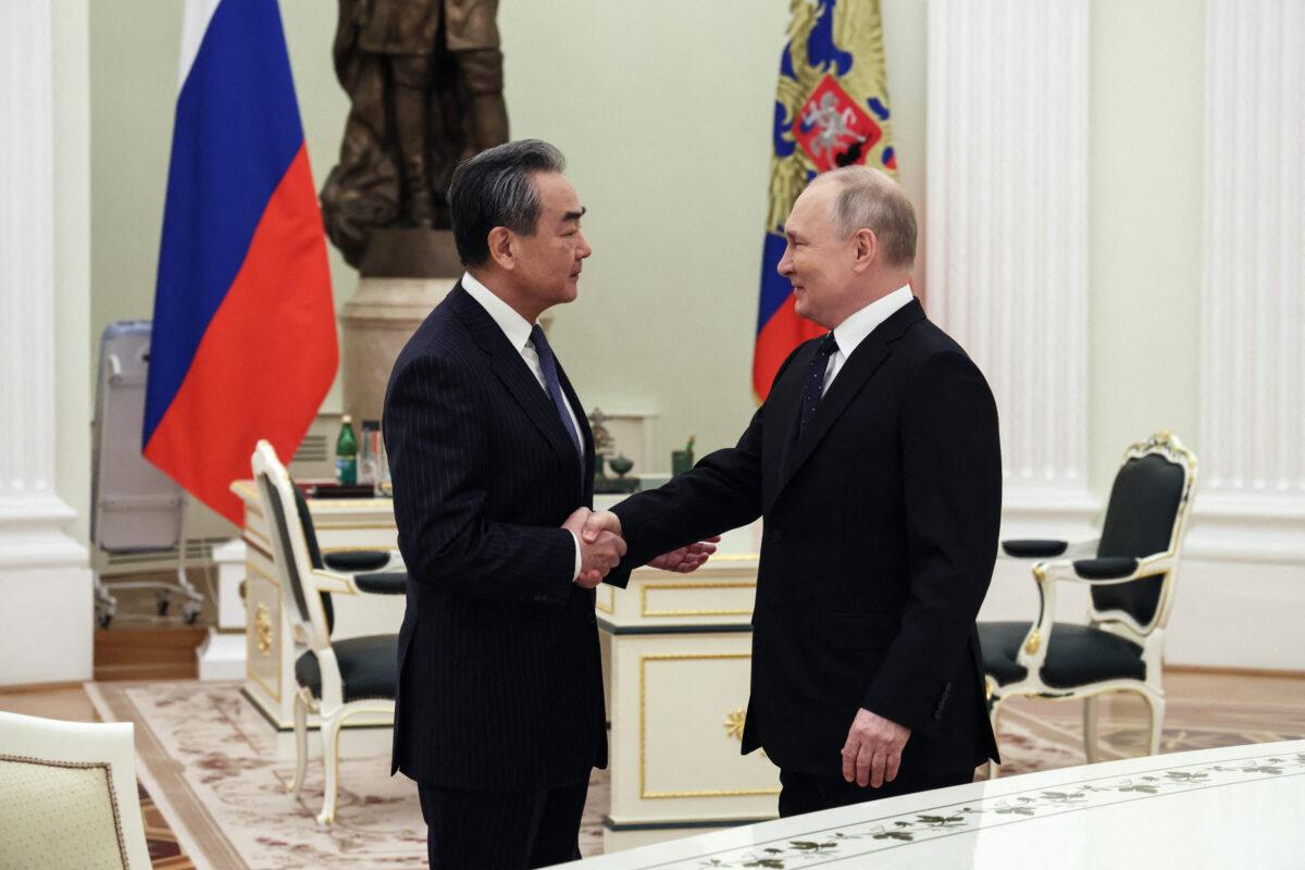 Russian President Vladimir Putin meets with China's Director of the Office of the Central Foreign Affairs Commission Wang Yi at the Kremlin in Moscow on Feb. 22, 2023. (Anton Novoderezhkin/Sputnik/AFP via Getty Images)