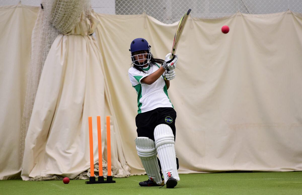 A girl practices her batting in the nets at a cricket ground in London on Nov. 11, 2015. (Dan Mullan/Getty Images)