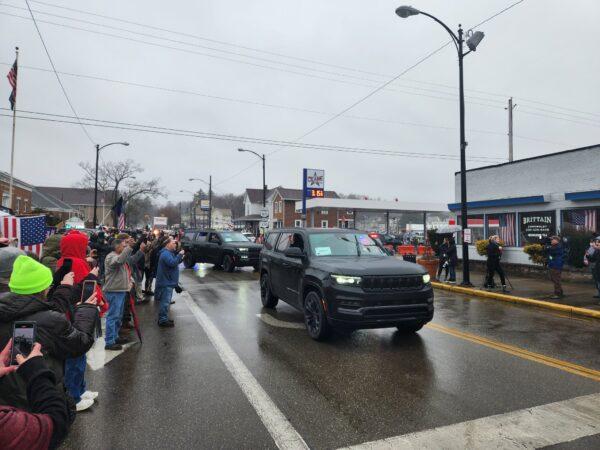 Supporters of former President Donald Trump line the streets of East Palestine, Ohio, to catch a glimpse of him as he drives by. (Jeff Louderback/The Epoch Times)