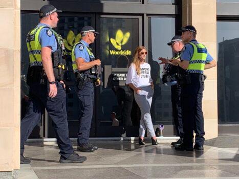Police charged a protester with one count of criminal damage after she spray-painted the Woodside Energy logo on the front doors of the Western Australia parliament in Perth, Australia, on Feb. 22, 2021. (Courtesy of Disrupt Burrup Hub)