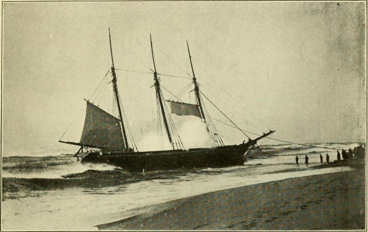 The three-masted schooner, Warren Sawyer, run aground in 1884. (<a href="https://commons.wikimedia.org/wiki/File:GARDNER(1915)_Wrecks_around_Nantucket_-1884-12-22_Schooner_WARREN_SAWYER,_ashore_at_Surfside._(14763165852).jpg">Public Domain</a>)