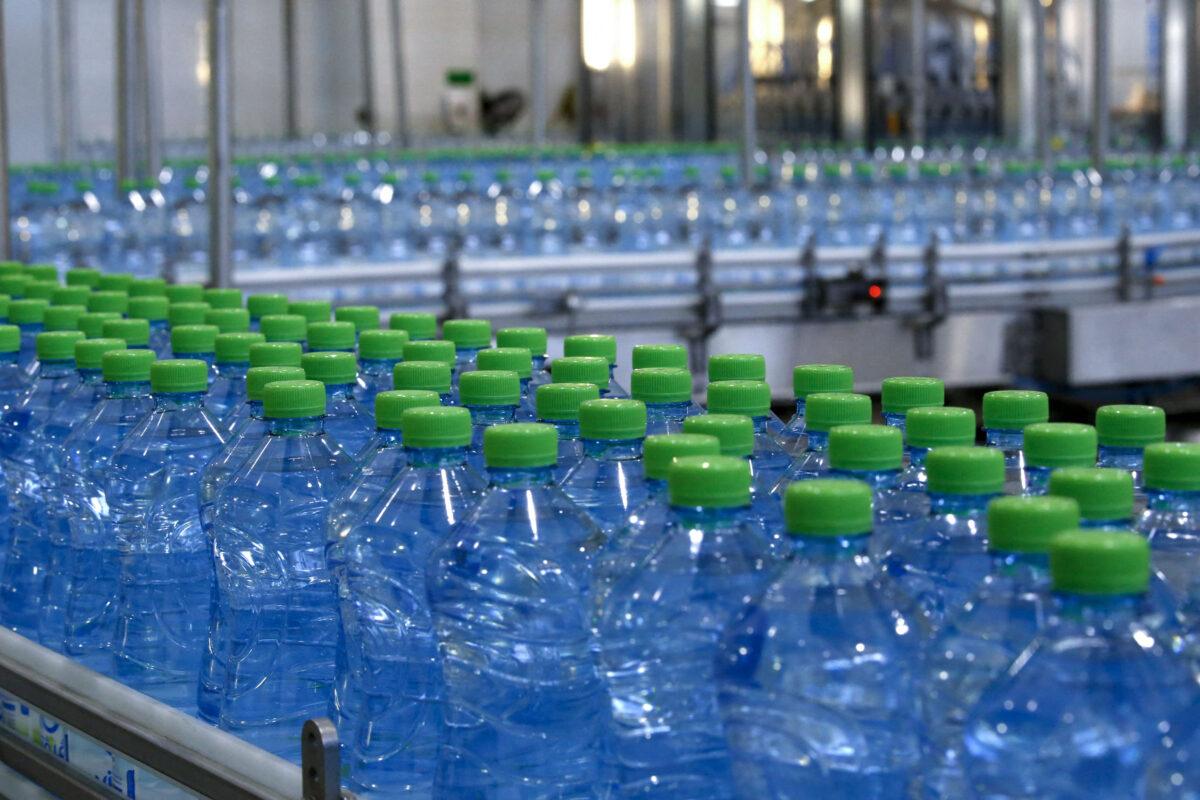 Plastic bottles of mineral water are seen on an assembly line in the Al-Junaidi mineral water factory in the West Bank city of Hebron, on February 5, 2020. (Hazem Bader/AFP via Getty Images)