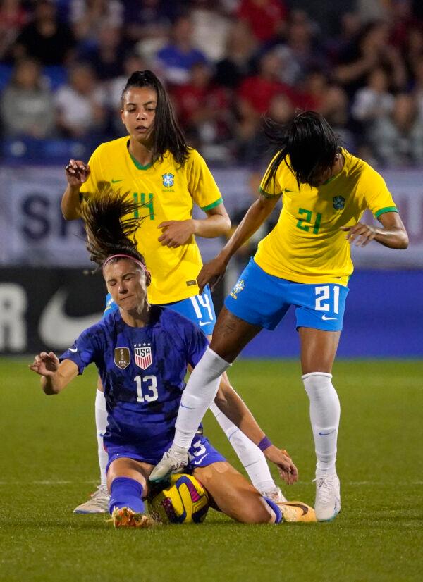 Alex Morgan (13) of the United States collides with Kerolin (21) of Brazil and Lauren (14) of Brazil during the first half in the 2023 SheBelieves Cup match at Toyota Stadium in Frisco, Texas, on Feb. 22, 2023. (Sam Hodde/Getty Images)