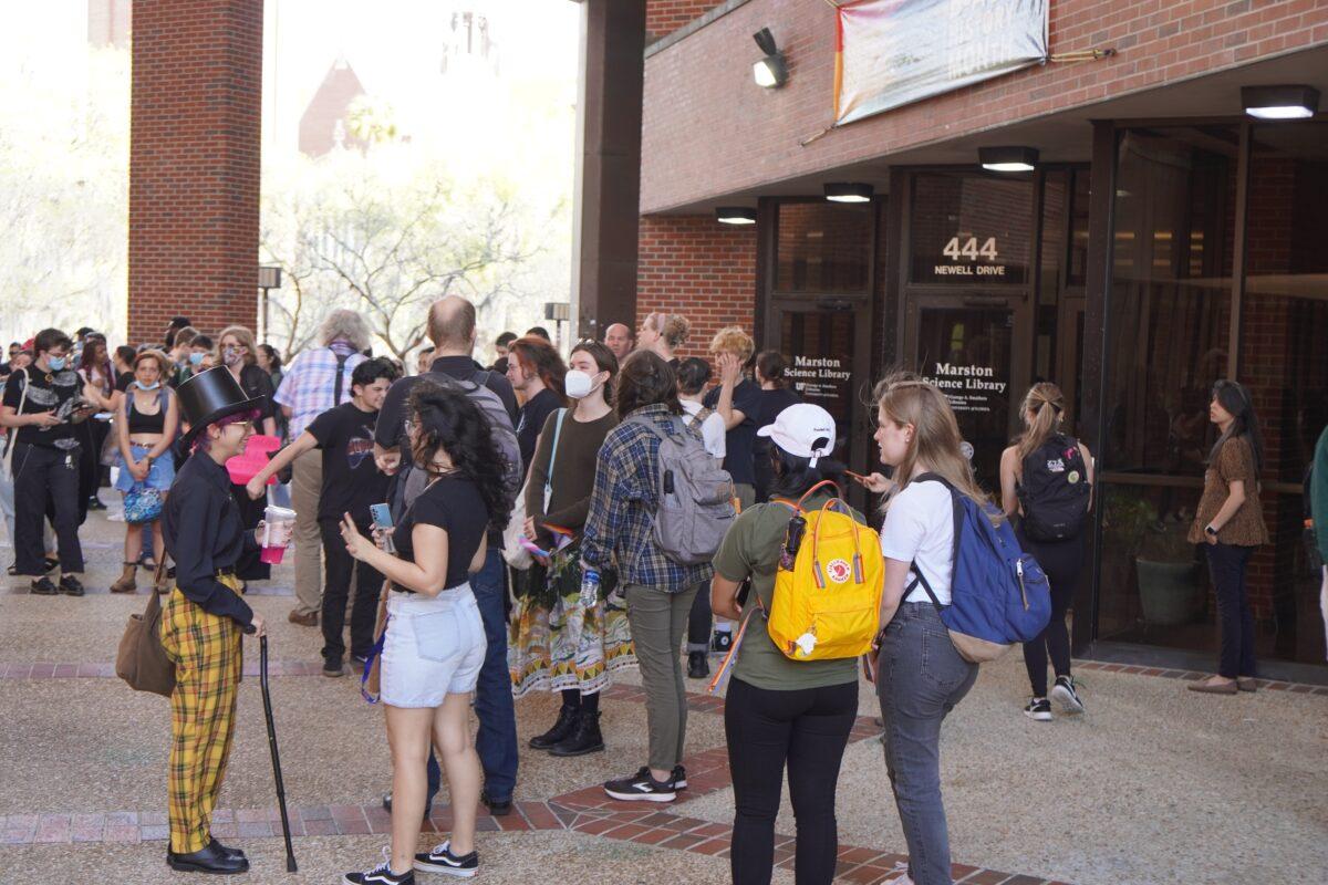 About 100 students at the University of Florida gather at the Marston Science Library on the campus in Gainesville, Fla., on Feb. 23, 2023, as part of a planned "walkout" to protest against Republican Gov. Ron DeSantis's efforts to curb Diversity, Equity, and Inclusion (DEI) programs in public universities and colleges around the state. (Nanette Holt/The Epoch Times)