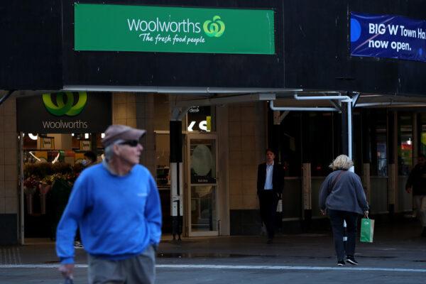 Pedestrians walk past a Woolworths supermarket in Sydney, Australia, on Aug. 24, 2022. (Lisa Maree Williams/Getty Images)