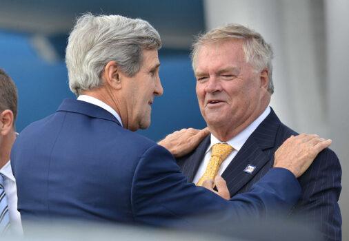 Former US Secretary of State John Kerry (L) greeted by then-Australian Ambassador to the US Kim Beazley on his arrival in Sydney, Australia, on Aug. 11, 2014. (Peter Parks - Pool/Getty Images)