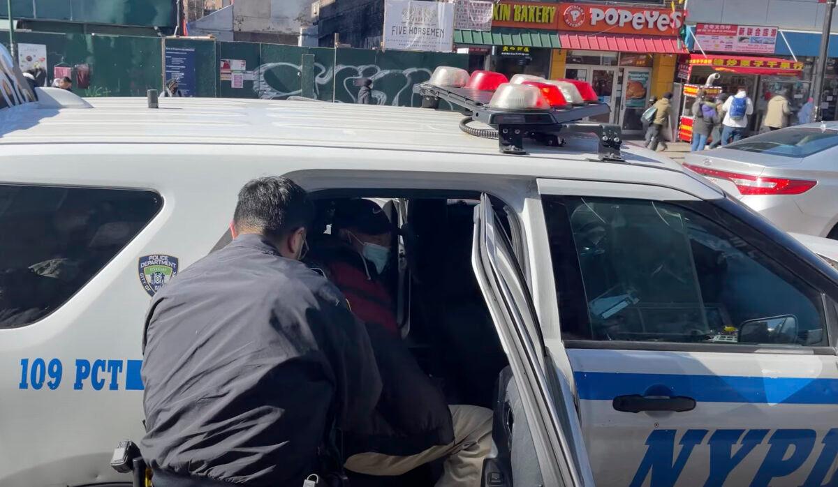 Police arrest Qi Zhongping, who faces charges for assaulting Falun Gong practitioners in the Flushing neighborhood of Queens, N.Y., on Feb. 18, 2023. (Screenshot via The Epoch Times)