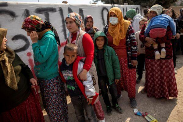 People affected by the deadly earthquake receive aid in Hatay, Turkey, on Feb. 24, 2023. (Eloisa Lopez/Reuters)